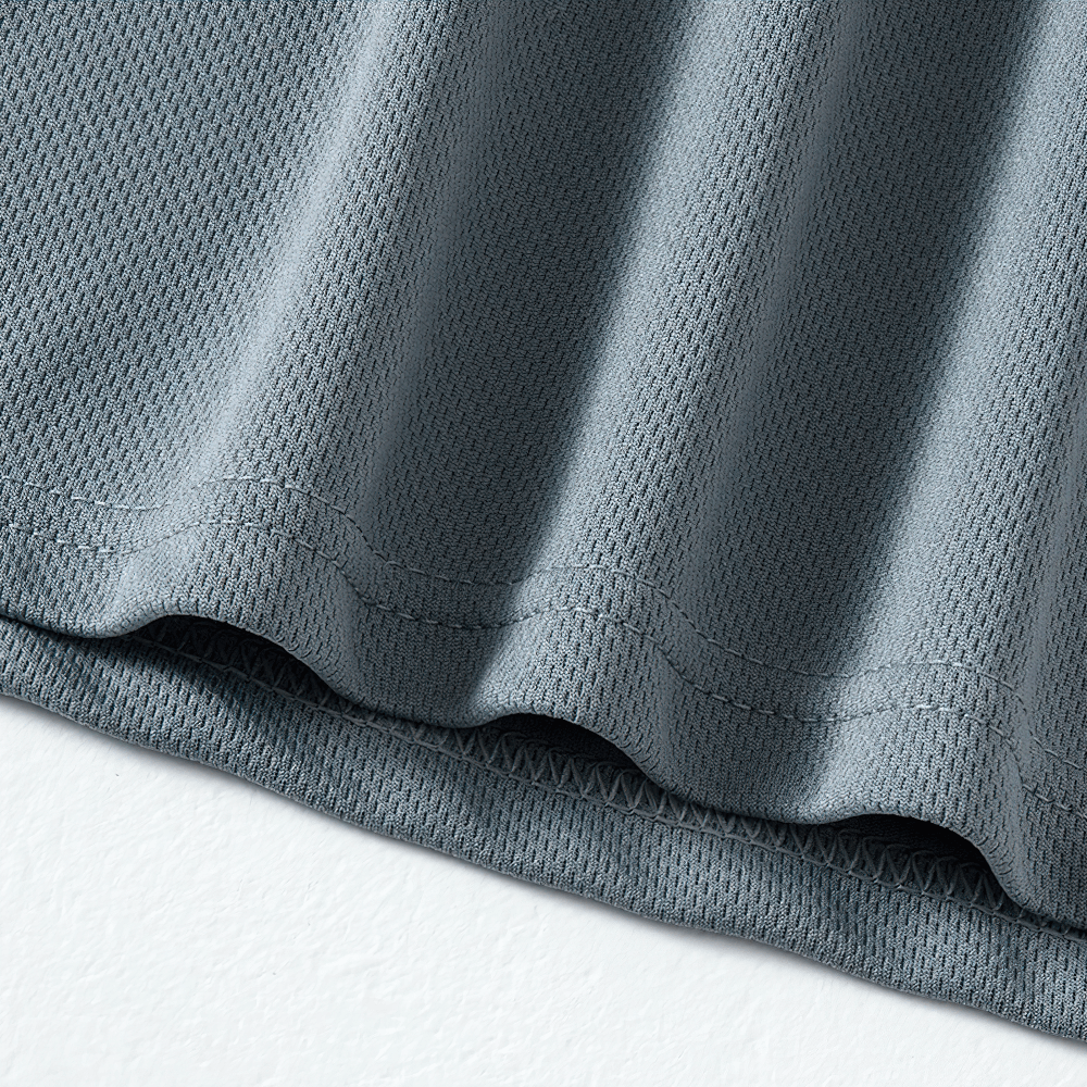 Close-up of gray quick-drying performance T-shirt fabric showcasing breathable, moisture-wicking texture for sports and activewear.